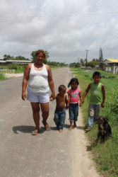 Taking a walk along the Essequibo Coast Public Road: Naomi Fredericks with nephew Lerone, niece Chelsea, and son Romel 