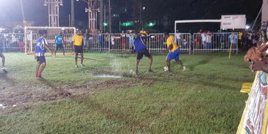 Devon Charles (right) of North East La Penitence trying to evade the impending challenge from Devon Dooker of Albouystown during their matchup at the Santos Training Area in the Ministry of Health/Petra Organization Soft Shoe Championship.