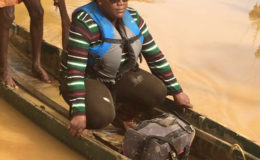 Junior Natural Resources Minister Simona Broomes crossing the Konwaruk  River on her way to the backdam
