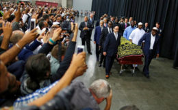 Worshipers and well-wishers take photographs as the casket with the body of Muhammad Ali is brought for his jenazah. REUTERS/Carlos Barria