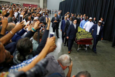 Worshipers and well-wishers take photographs as the casket with the body of Muhammad Ali is brought for his jenazah. REUTERS/Carlos Barria