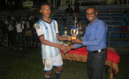Omar Brewley collecting the Most Valuable Player (MVP) accolade from UDFA Boss Sharma Solomon for his exploits throughout the tournament
 