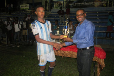 Omar Brewley collecting the Most Valuable Player (MVP) accolade from UDFA Boss Sharma Solomon for his exploits throughout the tournament   