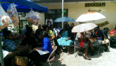 The teachers of Brickdam Secondary during their sit out yesterday in front of their school building
