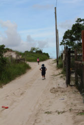 The children seen here had to walk up this hill before going downhill to their homes. 