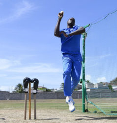 Jason Holder sends down a delivery during a practice session, with a pair of gloves placed on the stumps in honour of the legendary late boxer Muhammad Ali. (Photo courtesy WICB Media) 