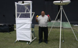 Guyana Cricket Board president and CGI executive Drubahadur shows off the local franchise’s new bowling machines.