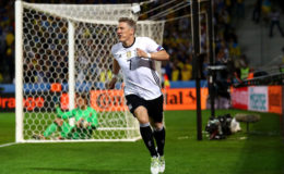 Bastian Schweinsteiger celebrates his stoppage time goal which sealed the 2-0 win for Germany over Ukraine in their Euro 2016 match yesterday.