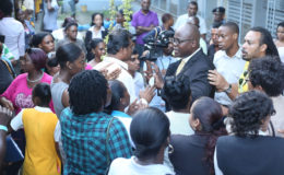 Chief Education Officer Olato Sam (right of centre with glasses) was bombarded with questions from irate parents during the meeting held yesterday to discuss the temporary closure of the Brickdam Secondary School.  (Keno George photo)
