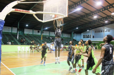 GTI’s Roger John in the process of dunking against the Bishops’ High during their u-19 quarterfinal matchup at the Cliff Anderson Sports Hall.