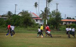 Action between Canje Secondary (red) and Overwinning in the Digicel Secondary Schools Football Championships at the Burnham park ground in Berbice yesterday.