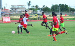 Action between Diamond Secondary (red) and Soesdyke Secondary (white) in the Digicel Football Schools Championship at the Leonora Sports Facility.