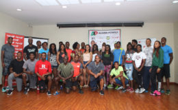 The athletes competing in today’s Aliann Pompey Invitational pose for a photo yesterday at the Princess Ramada Hotel. 