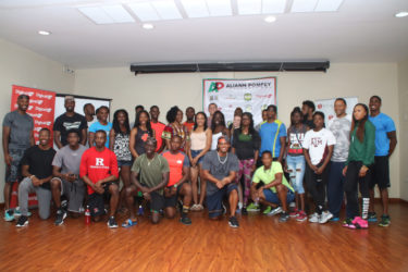 The athletes competing in today’s Aliann Pompey Invitational pose for a photo yesterday at the Princess Ramada Hotel. 