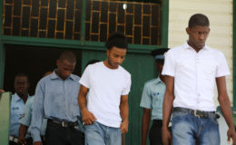Leaving the courtroom, from left to right: Dameion Millington, Nicolas Narine and Warren McKenzie after they were found guilty by Magistrate Zamilla Ally-Seepaul in the robbery of Justice Nicola Pierre and her husband Mohamed Chan.