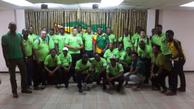 The victorious ‘Green Machine’ national rugby team pose with Director of Sport, Chris Jones and president of the union, Peter Green shortly after arriving at the Cheddi Jagan International Airport. 