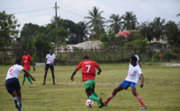 Action between Mackenzie High School (red) and Wisburg Secondary in the Digicel Schools Football Championship at the Wisburg School ground