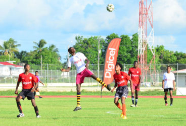 Action between Xenon Secondary (white) and Friendship Secondary in the Digicel Schools Football Championship at the Leonora Sports Facility  