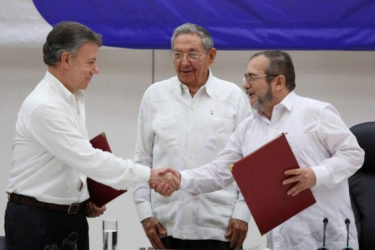 Cuba's President Raul Castro (C) looks as Colombia's President Juan Manuel Santos (L) shakes hands with FARC rebel leader Rodrigo Londono, better known by his nom de guerre Timochenko, after signing a historic ceasefire deal between the Colombian government and FARC rebels in Havana, Cuba, June 23, 2016. REUTERS/Alexandre Meneghini