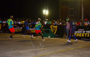 Gregory Richardson (second from left)  of Sparta Boss in the process of scoring one of his two goals after collecting a pass from teammate Devon Millington (right) during their lopsided win over BV-B in the Greatest of the Streets’ National Championship at the National Cultural Centre tarmac
