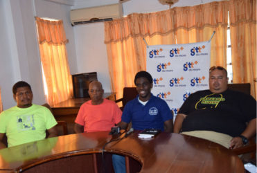 Vice President of the GRFU, Joshua Griffith (centre) makes a point  during yesterday’s press briefing. Griffith is surrounded by Coach of the U-19 team, Troy Yhip (right) and coach of the senior team, Laurie Adonis (second from left).  