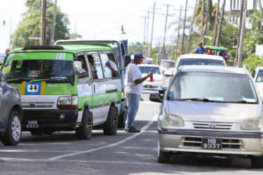 A water vendor attending to his customers at Lamaha Street and Vlissingen Road (Photo by Keno George) 