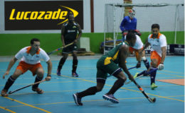 Aroydy Branford (centre) of Hikers in the process of initiating an attack while being watched by Peter DeGroot (right) and Steven Xavier (left) of GCC during their team’s fixture at the National Gymnasium.