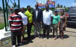 Minister of State,  Joseph Harmon (centre) with Chairman of the Lancaster/Hogstye NDC Forbes Moore (third from right) along with other members of the community during one of his visits to East Berbice-Corentyne.  (Ministry of the Presidency photo)