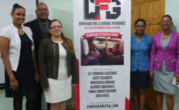 Clarence Perry (second from left) and Melissa De Santos (third from left) with other staff at the launching
