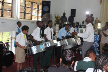 Members of the Pan Wave Steel Orchestra performing a final tribute to their colleague during the funeral service yesterday. 