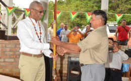 President David Granger receiving an arrow and bow, which he called a "silent missile" from Daniel Allicock of Surama Village.  (Ministry of the Presidency photo)