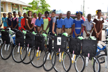 Some of the top students in the Upper Demerara/Upper Berbice Region display their bicycles and backpacks (Ministry of the Presidency photo) 