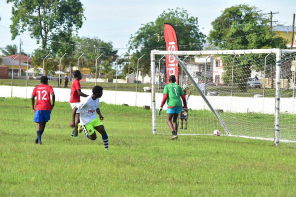 A Bishops’ High School player scores against Tutorial High during their meeting at the Camp Ayanganna ground in the Digicel Schools Football Championships yesterday.