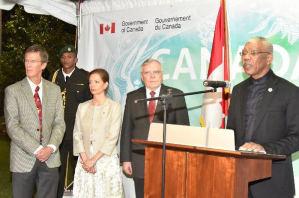 President David Granger addressing the attendees at the ‘Canada Day’ reception, which was held, on Friday evening, at the High Commissioner’s residence. High Commissioner Pierre Giroux and his wife Blanca are next to him. (Ministry of the Presidency photo)   