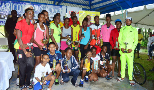 The top performers of the seventh annual Seven Seas Multivitamins and Dr. Chase Nerve Foods 35-mile road race pose with their spoils following the event yesterday at West Demerara. (Orlando Charles photo)