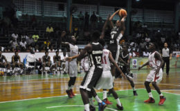 Guyana’s Jordan Alphonso attempting a jump shot over several Suriname players during their team’s matchup in the CBC u16 Championship at the Cliff Anderson Sports Hall.
 
