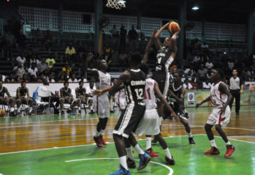 Guyana’s Jordan Alphonso attempting a jump shot over several Suriname players during their team’s matchup in the CBC u16 Championship at the Cliff Anderson Sports Hall.   