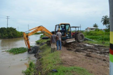 Excavator clearing drainage canal in MMA district, Region Five canal (GINA photo)