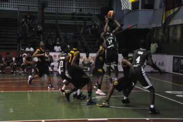 Guyana’s Jordan Alphonso attempting a jump shot amid several Jamaican players during their matchup in the Caribbean Basketball Confederation (CBC) Boys u16 Championship at the Cliff Anderson Sports Hall.