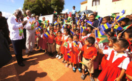 President David Granger (second from left) , Barbados Prime Minister Freundel Stuart (left)  and the visiting delegation received a warm welcome at the Lethem airstrip by school children of Upper Takutu-Upper Essequibo, who were waving the flags of Guyana and Barbados (Ministry of the Presidency photo)