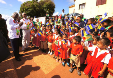 President David Granger (second from left) , Barbados Prime Minister Freundel Stuart (left)  and the visiting delegation received a warm welcome at the Lethem airstrip by school children of Upper Takutu-Upper Essequibo, who were waving the flags of Guyana and Barbados (Ministry of the Presidency photo)