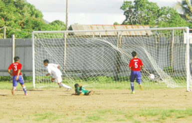 Kenbert Salvador (centre) in the process of celebrating after scoring the opening goal during their side’s lopsided win over Aishalton in the Digicel Schools Foot Championship David Coates (left) off to celebrate his second goal against Aishalton Secondary in the Digicel Schools Football Championship 