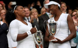 Sister ACT! Sisters Venus and Serena Williams celebrate after winning the women’s doubles title at the All England Club yesterday. (Reuters photo)