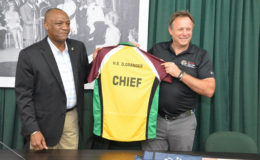 Chief Operations Officer of the Caribbean Premier League Franchise, Mr. Pete Russell presents the ‘Chief’ Amazon Warriors t-shirt for President David Granger to Minister of State, Mr. Joseph Harmon.
