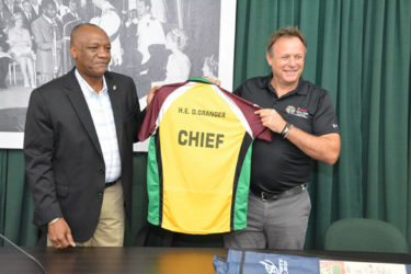 Chief Operations Officer of the Caribbean Premier League Franchise, Mr. Pete Russell presents the ‘Chief’ Amazon Warriors t-shirt for President David Granger to Minister of State, Mr. Joseph Harmon. 