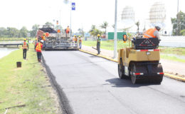 Road work crews were back on the job at Carifesta Avenue yesterday to complete the upgrading that had started in May, but was halted to allow for the Caricom Heads of Government summit held here last week. (Photo by Keno George)
