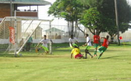 Job Caesar (No.10) of Chase Academy in the process of scoring his first goal against Bishops’ High during their matchup in the Georgetown North Zone final of the Digicel Schools Football Championship at the Camp Ayanganna ground
