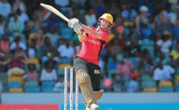 Left-hander Colin Munro strikes a boundary during his top score of 68 for Trinbago Knight Riders yesterday. (Photo courtesy CPL)