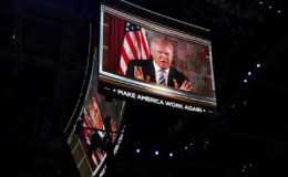 U.S. Republican Presidential Nominee Donald Trump is shown on video monitors as he speaks live to the crowd from New York at the Republican National Convention in Cleve-land, Ohio, U.S. July 19, 2016. REUTERS/Mario Anzuoni