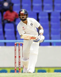 India captain Virat Kohli gathers runs down the ground during his unbeaten 143 on the opening day of the first Test against West Indies. (Photo courtesy WICB) 